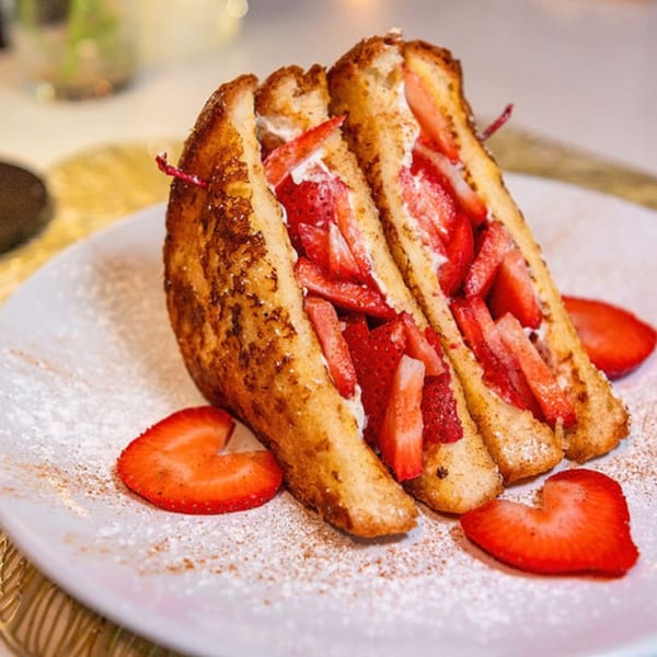 Laudy Bar Craft Kitchen's French toast stuffed with strawberries and cream, dusted with powdered sugar.